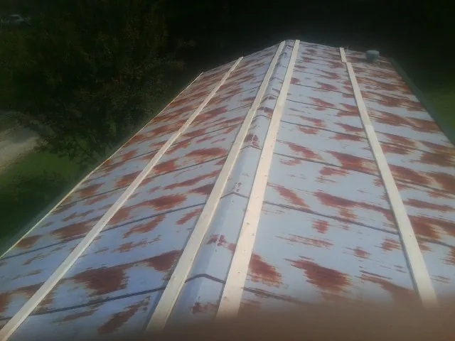 Rusted metal roof panels with new wood purlins before replacement — Storm Damage Roof Repair in Burnt Ranch by Roofing Brothers